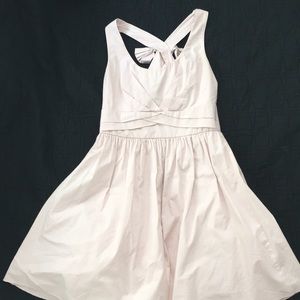 Pink dress with bow on the back and tool inside